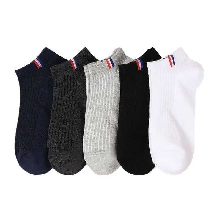 A collection of five pairs of mixed-color men's boat socks, displayed in a neat arrangement.
