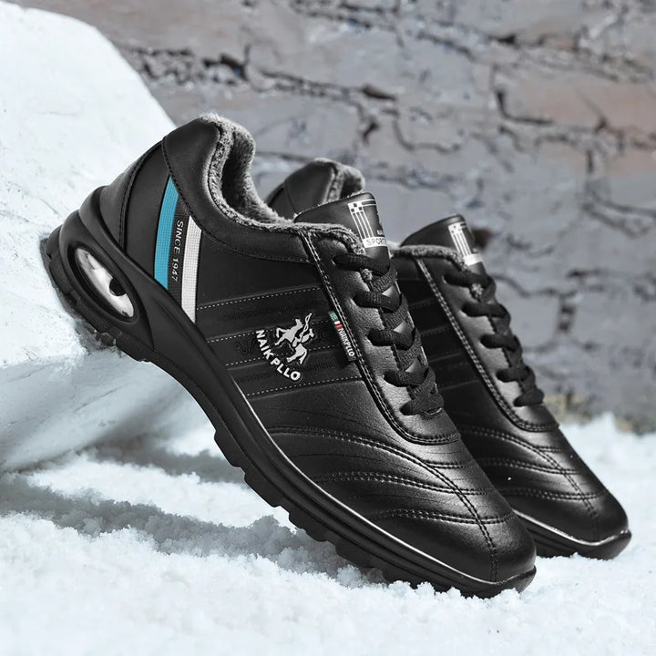 lack sneakers featuring blue detailing, displayed on snow with a stylish edge.
