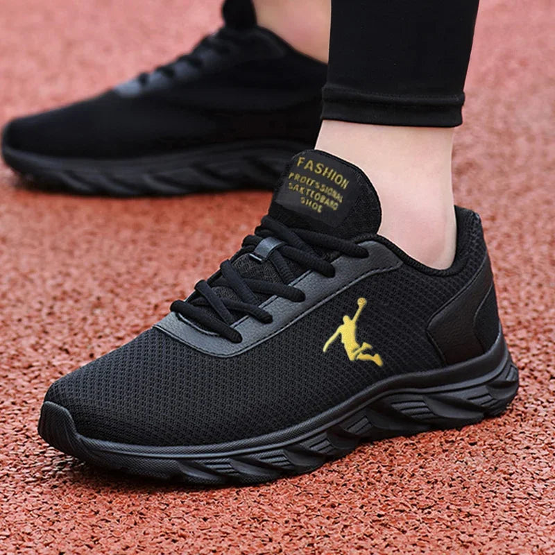 A black mesh sneaker featuring a gold logo, emphasizing a stylish and sporty look.