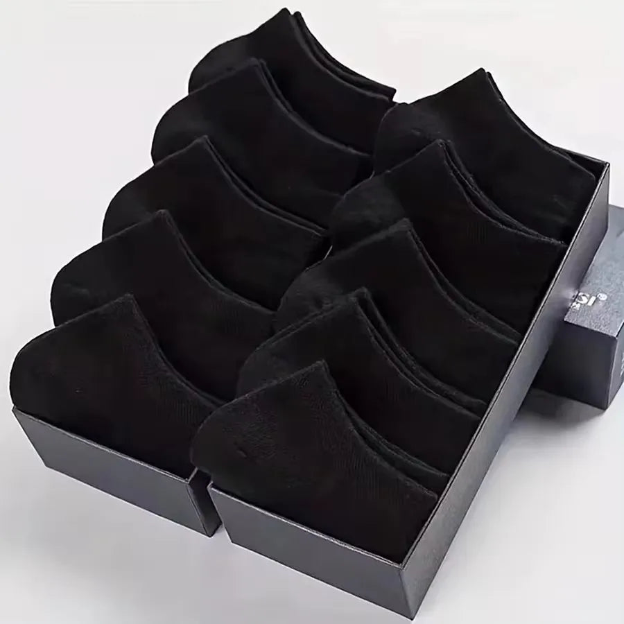 Folded stack of black no-show socks, showing soft and durable material.
