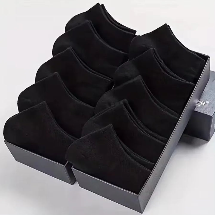 Folded stack of black no-show socks, showing soft and durable material.