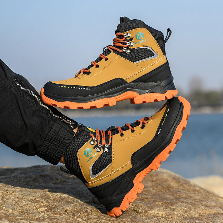 Slip-resistant work shoes with orange and black design.