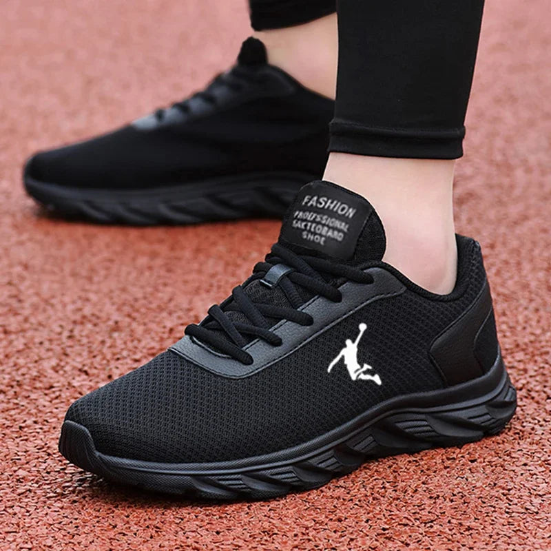 A front-angle view of black breathable sneakers, highlighting their lace-up closure and breathable mesh material.