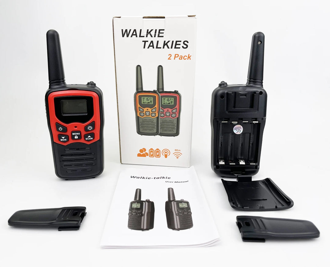 Two walkie talkies with accessories and packaging on a white background