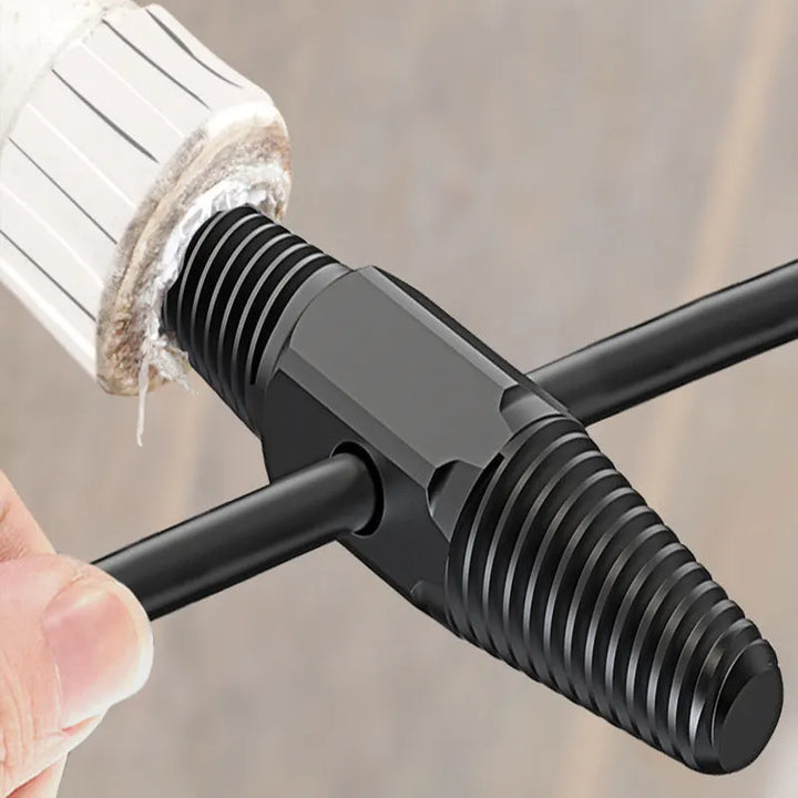 Black metal T-shaped tool being used on a white cylindrical object with a blurred background