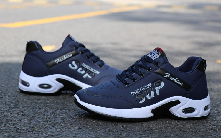 Men's waterproof sneakers photographed on the pavement for an outdoor performance look.