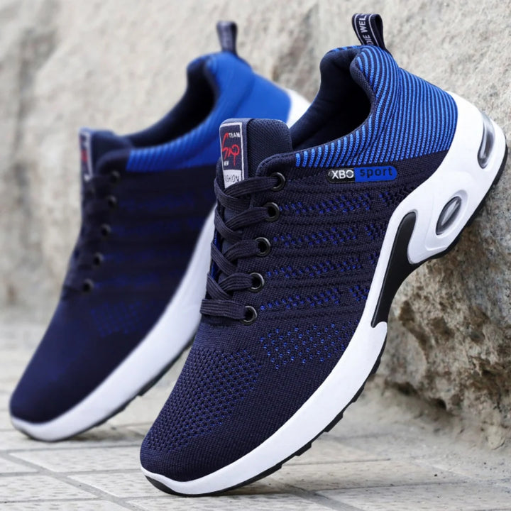 Stylish navy blue and white athletic shoes with lace-up closure.
