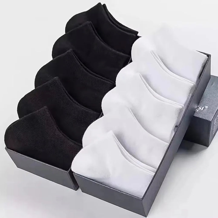 Rows of black and white no-show socks arranged in a set, perfect for bulk buying.