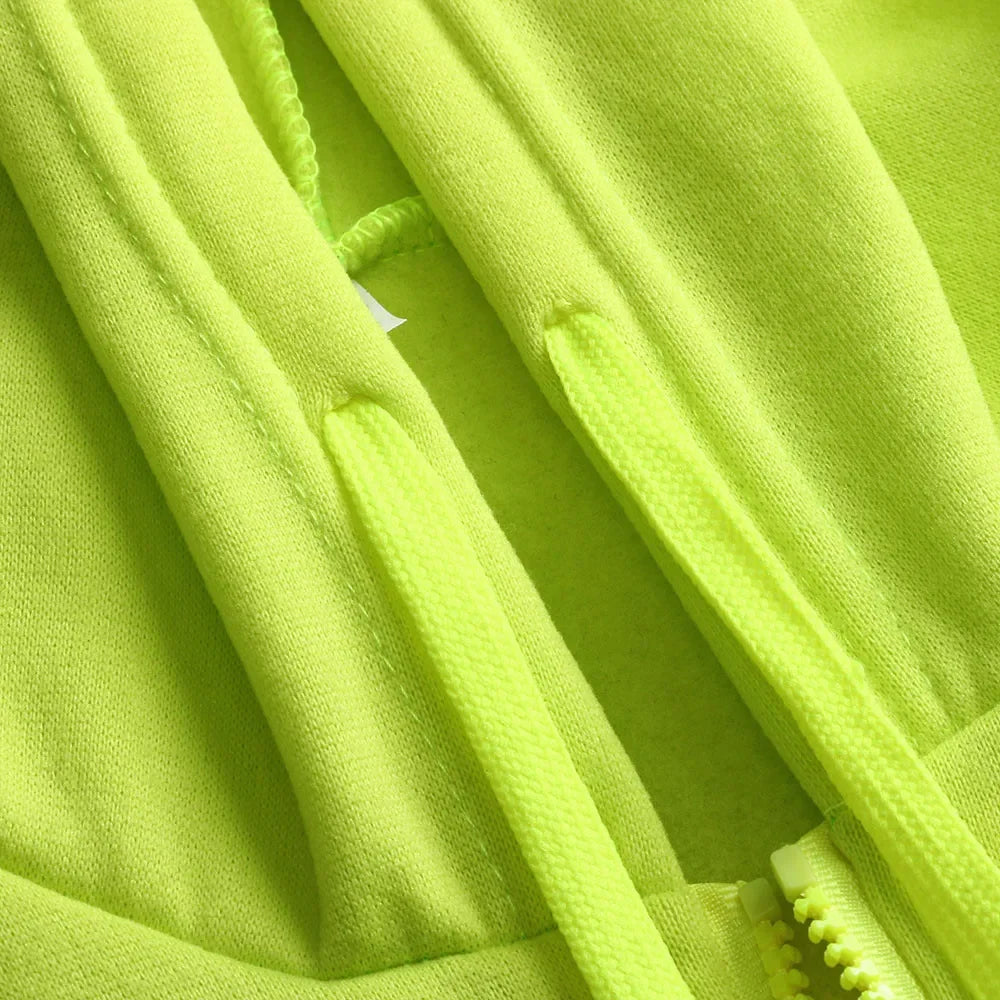 Close-up of a bright green fleece fabric with a zipper.