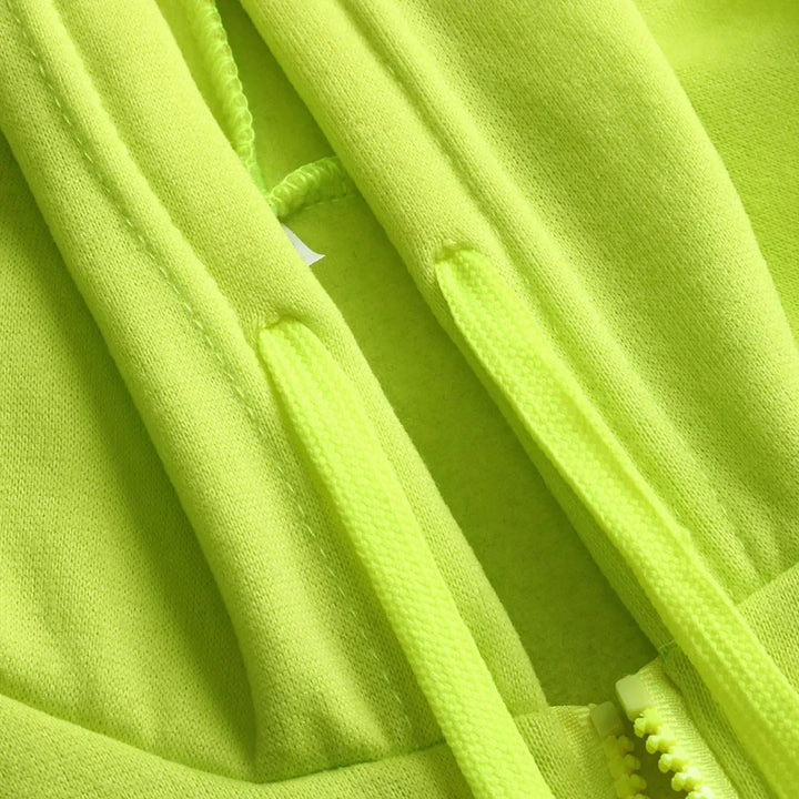 Close-up of a bright green fleece fabric with a zipper.
