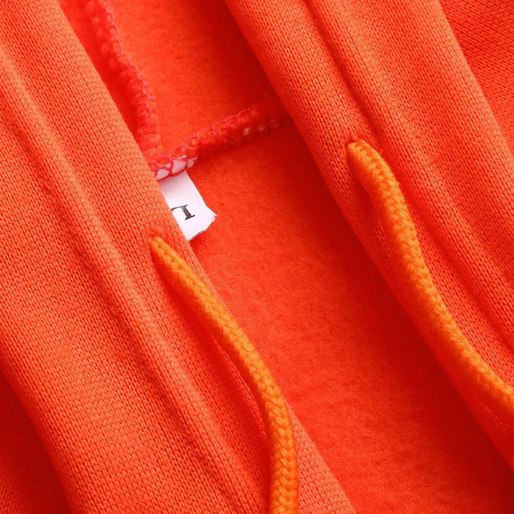 Close-up of orange fabric with a brand label visible