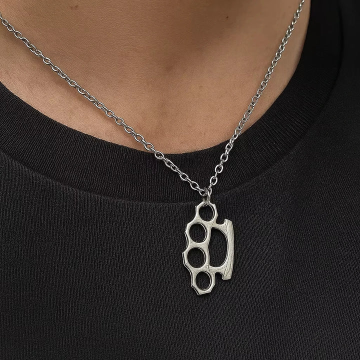 Silver knuckle duster necklace on a person wearing a black shirt