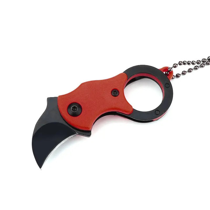 Keychain knife clipped onto backpack zipper pull