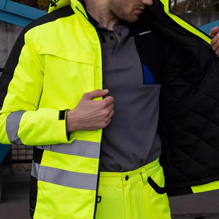Person wearing a high-visibility jacket with reflective stripes.