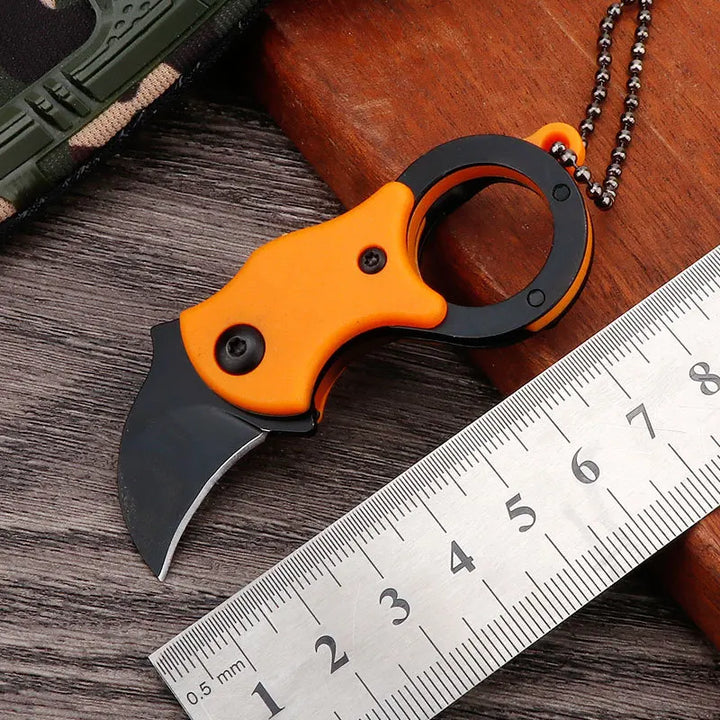 Knife handle shown with textured grip and lanyard hole