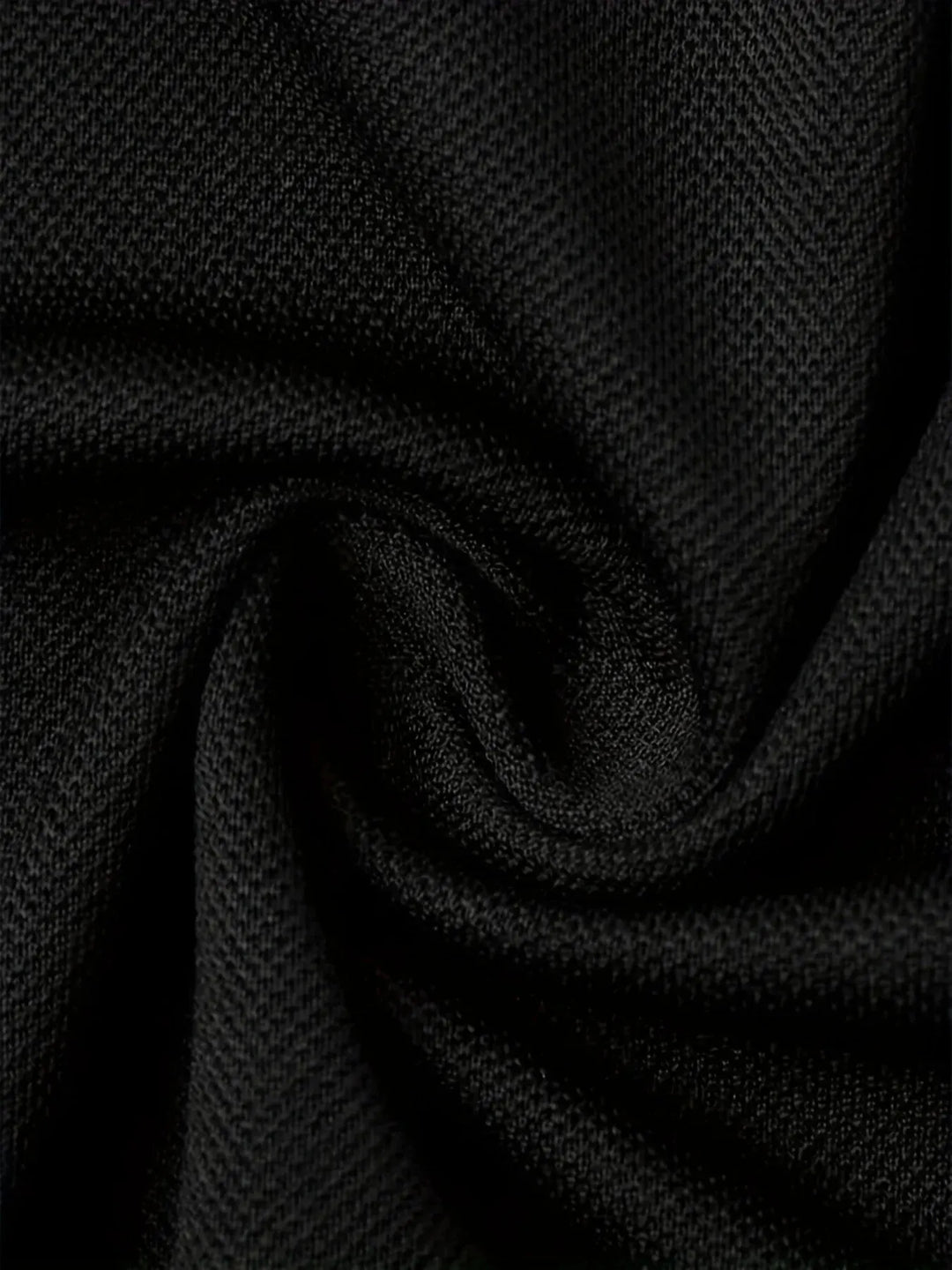 breathable polyester polo shirt fabric texture in solid black color.