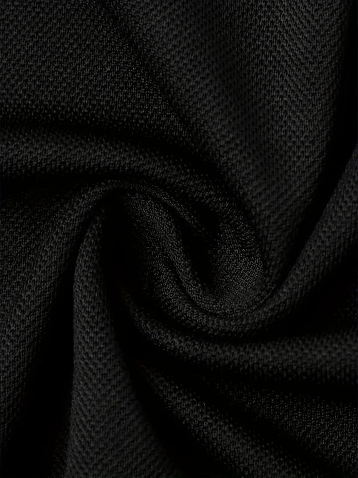 breathable polyester polo shirt fabric texture in solid black color.