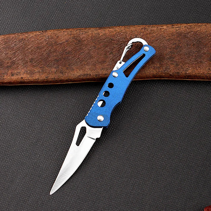 Folding knife with blue handle on a dark surface