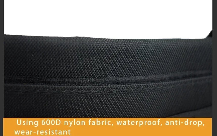 Close-up of black fabric with text about 600D nylon properties.