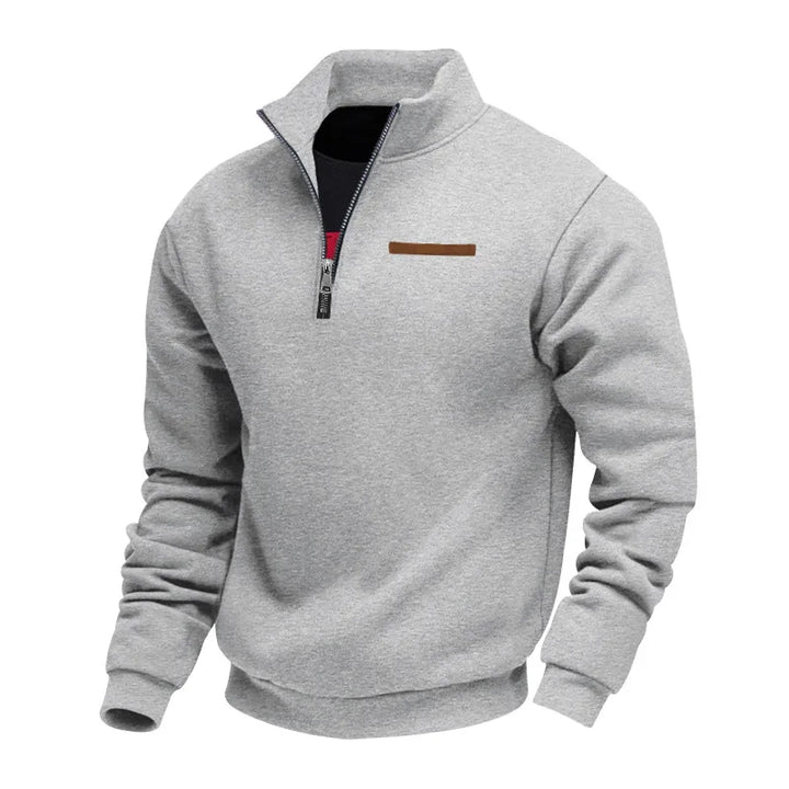 Gray pullover with a quarter zip on a white background