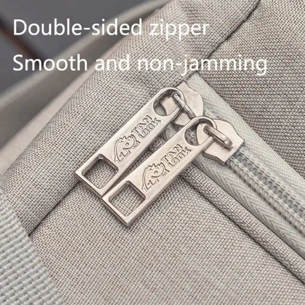 Close-up of a double-sided zipper on a gray fabric surface with 'TSA Lock' branding.