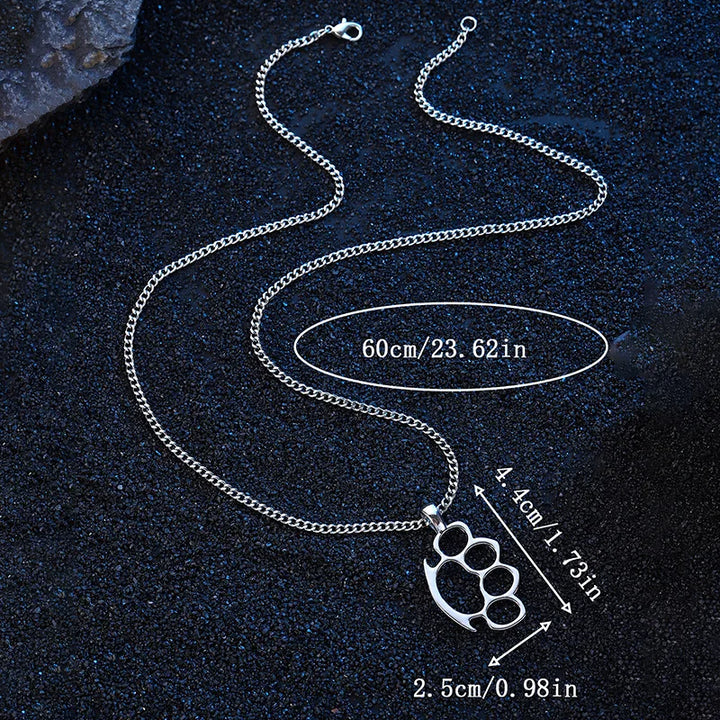 Silver chain necklace with knuckle duster pendant on a dark textured background
