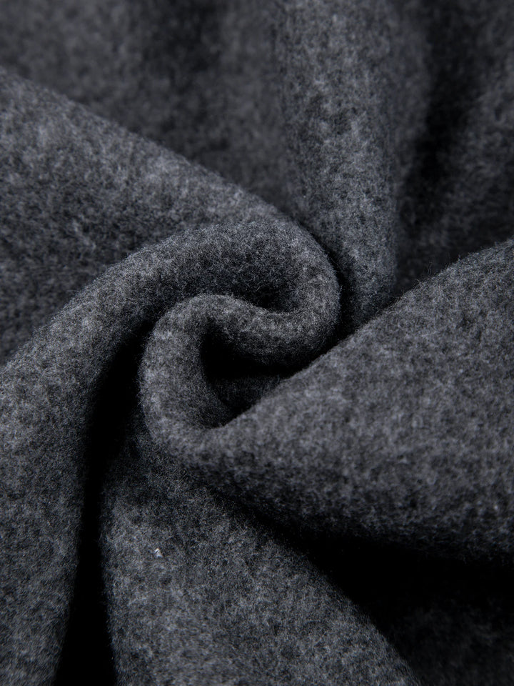 Close-up of dark gray fabric with a textured pattern