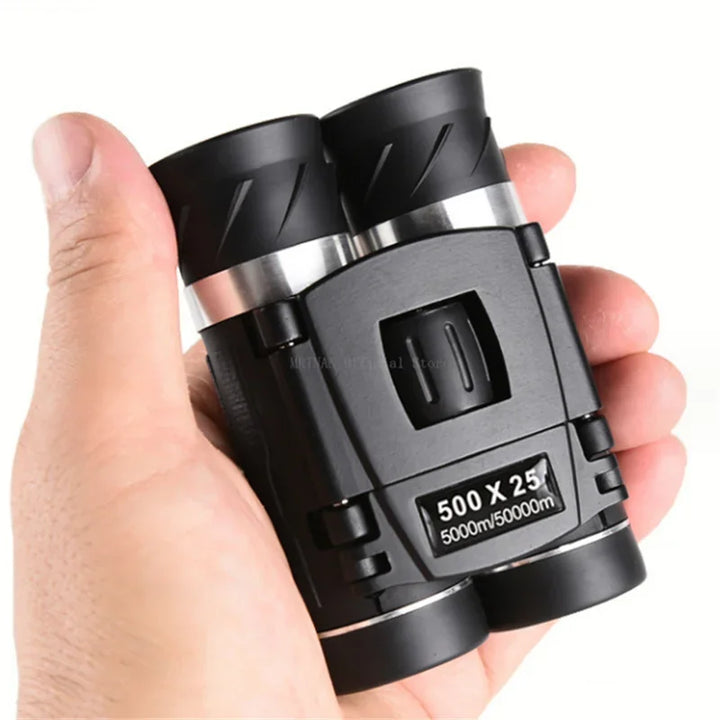 Black binoculars held in a hand with a white background