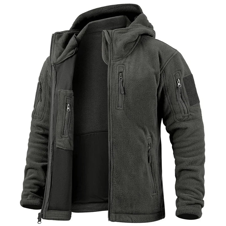 Dark green tactical jacket with multiple pockets and zippers on a white background