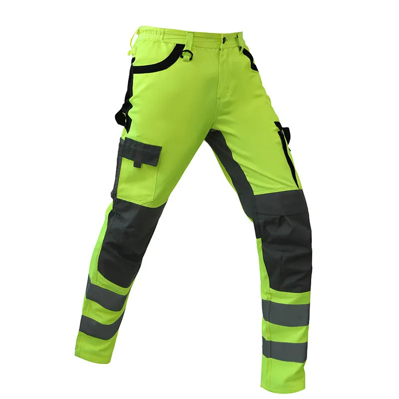 High-visibility work pants with green and black color scheme on a white background