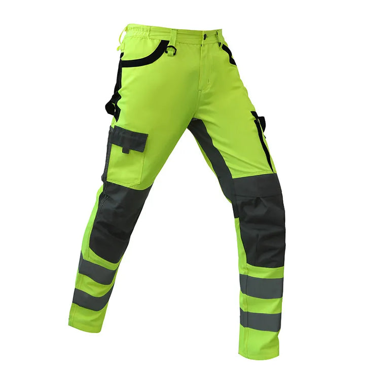 High-visibility work pants with green and black color scheme on a white background
