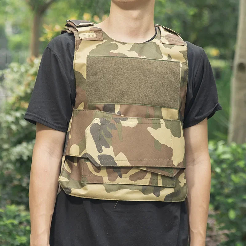Person wearing a camouflage tactical vest outdoors with greenery in the background