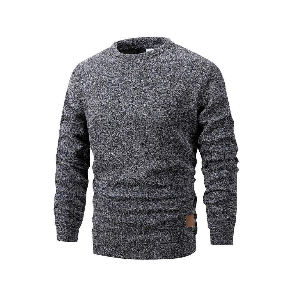 Gray marled sweater with a brown patch on a white background