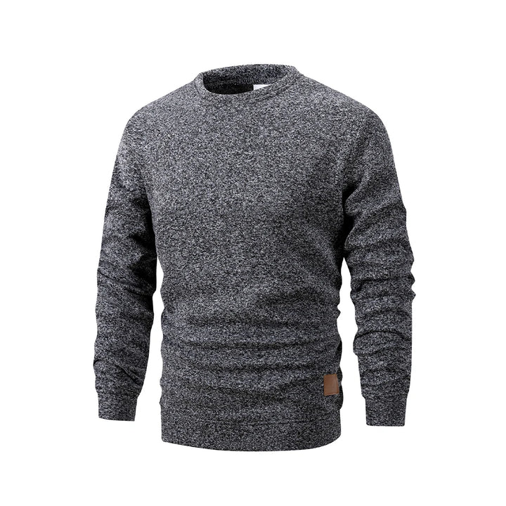 Gray marled sweater with a brown patch on a white background