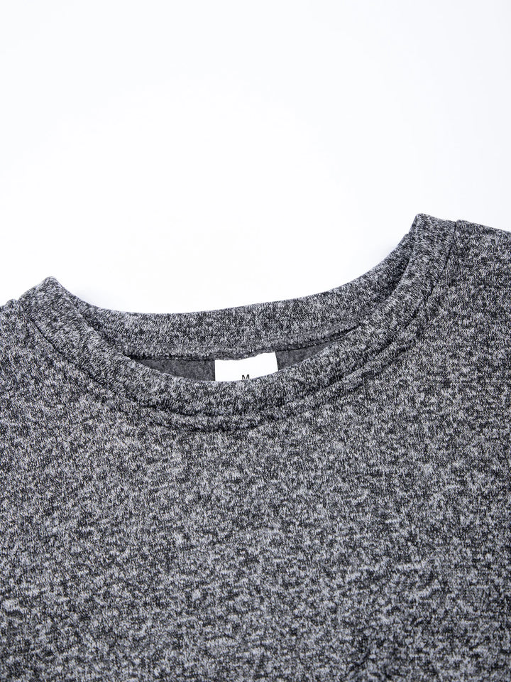 Close-up of a gray textured shirt collar with a visible brand label on a white background