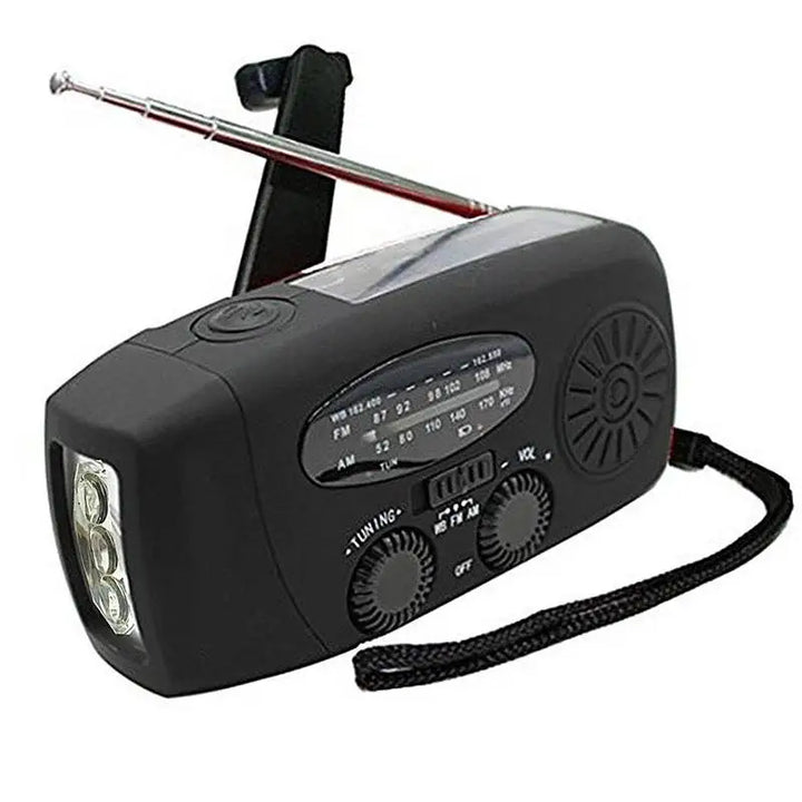 Black emergency radio with flashlight and antenna on a white background