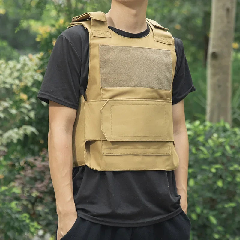 Person wearing a tan tactical vest outdoors with greenery in the background