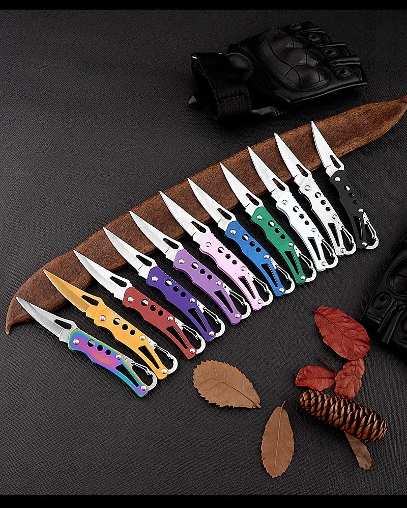 Set of colorful pocket knives on a brown leather sheath with leaves and pinecones on a dark background