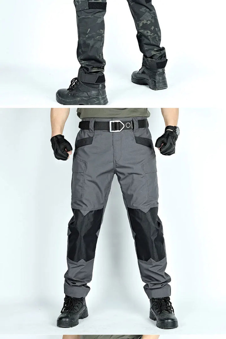 Tactical pants with black and gray color scheme worn by a person on a white background.