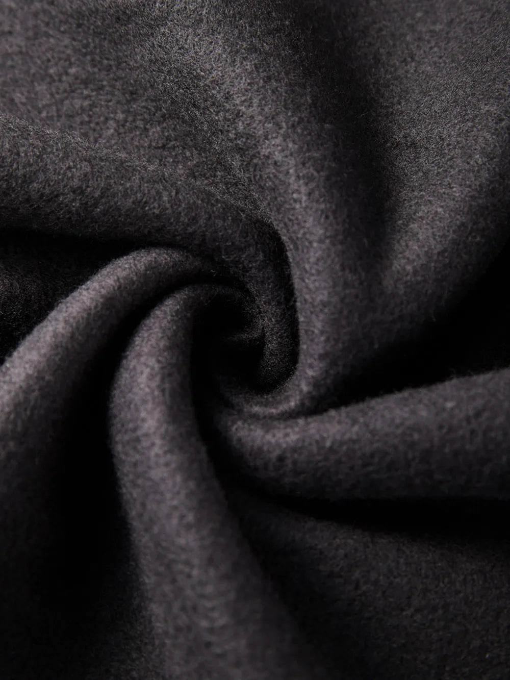 Close-up of dark gray fabric with a textured surface