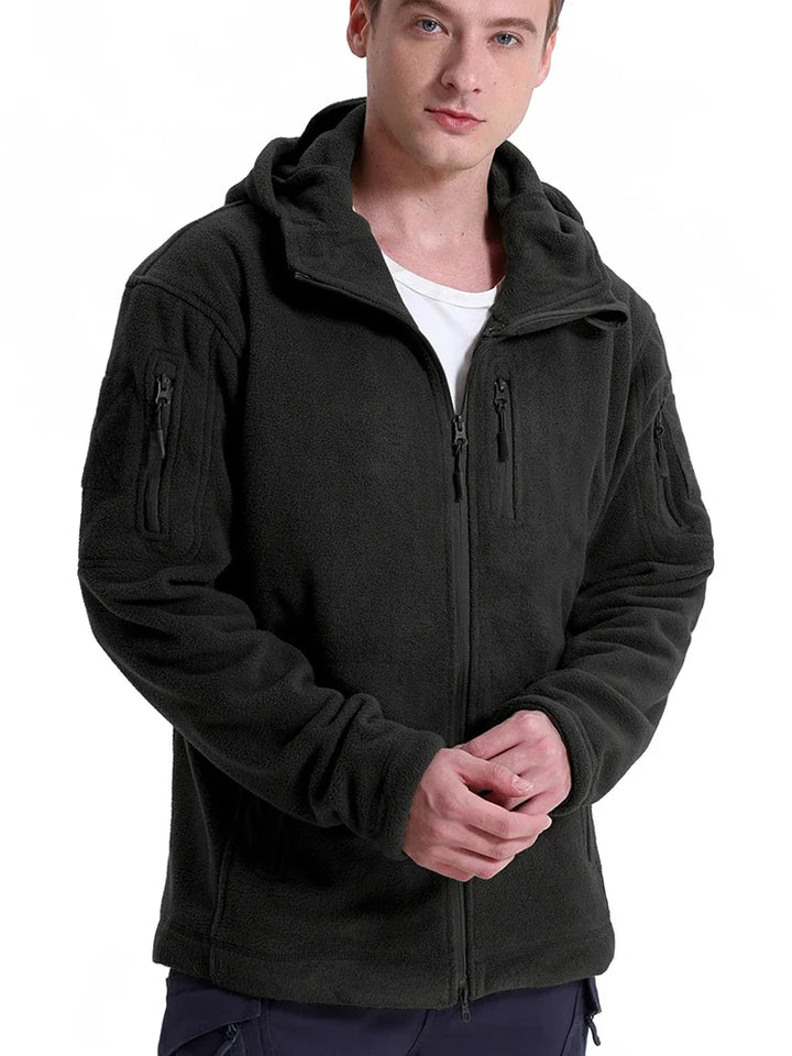 Man wearing a black tactical jacket on a white background