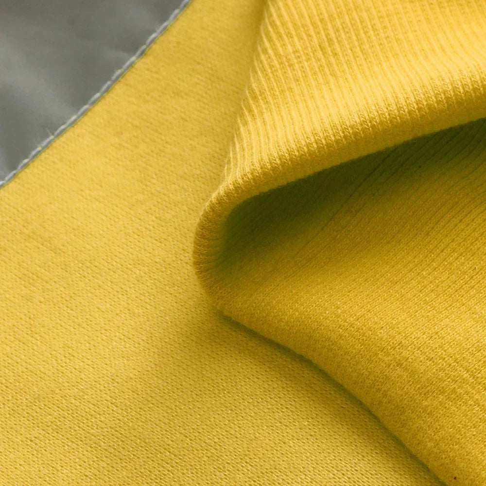Close-up of yellow fabric with a textured surface
