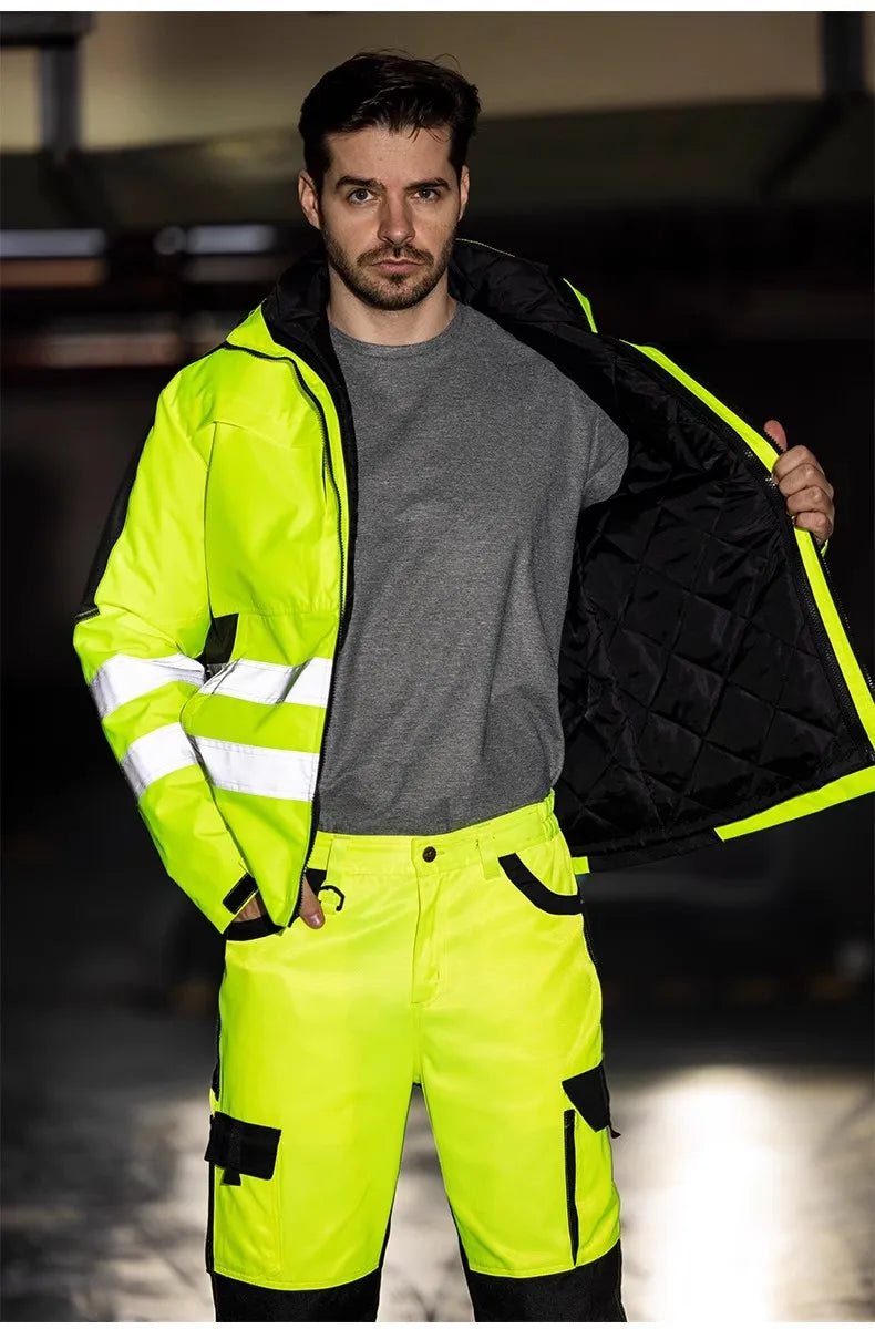 Person wearing a high-visibility safety suit with reflective elements.