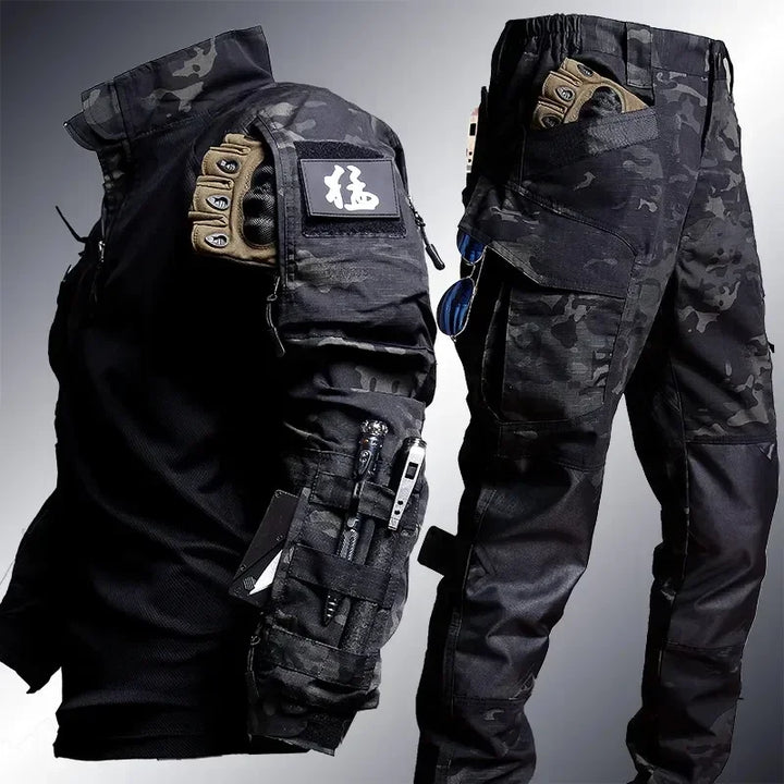 Tactical gear including a jacket and pants with various pockets and attachments on a gray background.