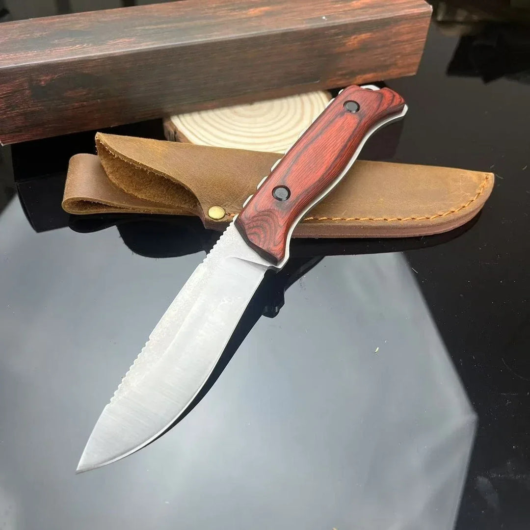 Knife with wooden handle and leather sheath on a reflective surface