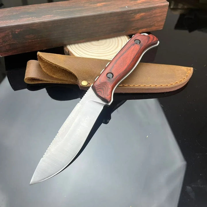 Knife with wooden handle and leather sheath on a reflective surface