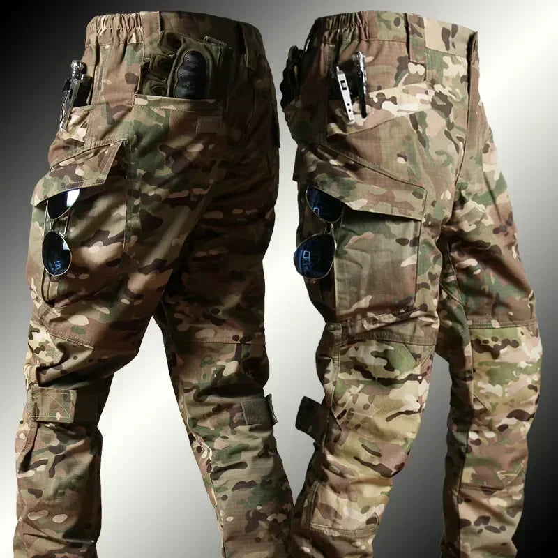 Camouflage pants with multiple pockets and attached sunglasses on a gray background