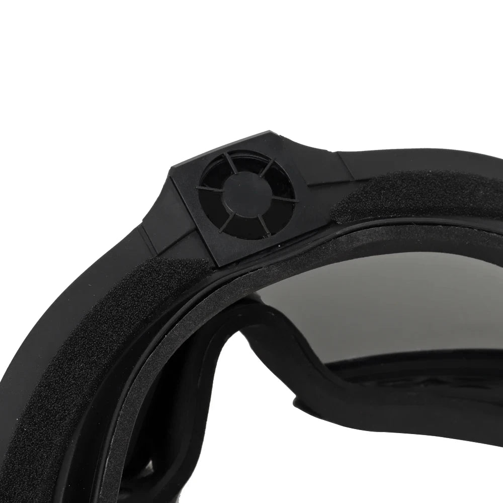 Close-up of a black goggle lens and frame on a white background