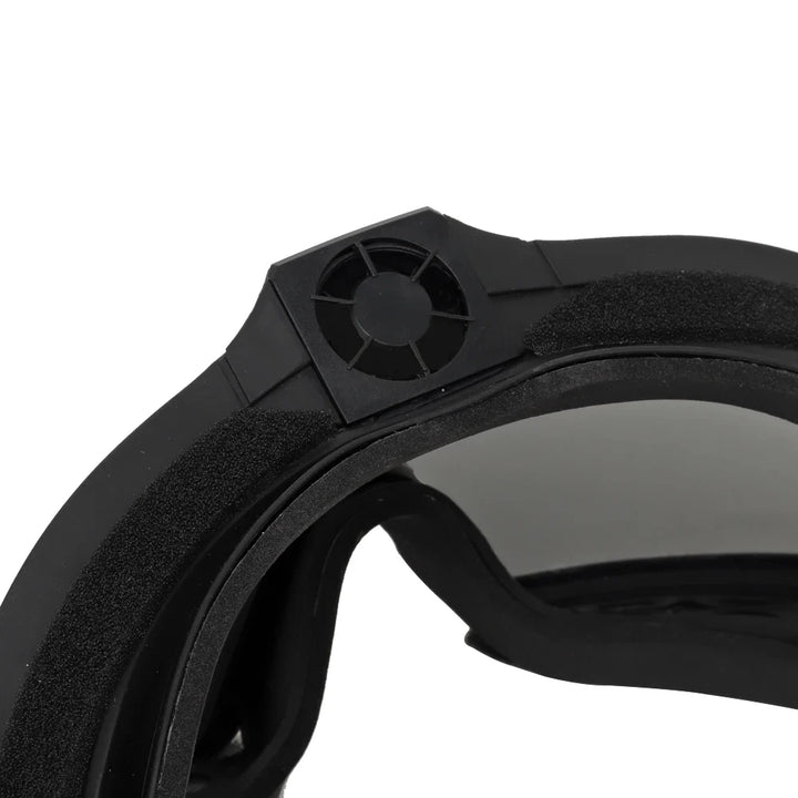 Close-up of a black goggle lens and frame on a white background