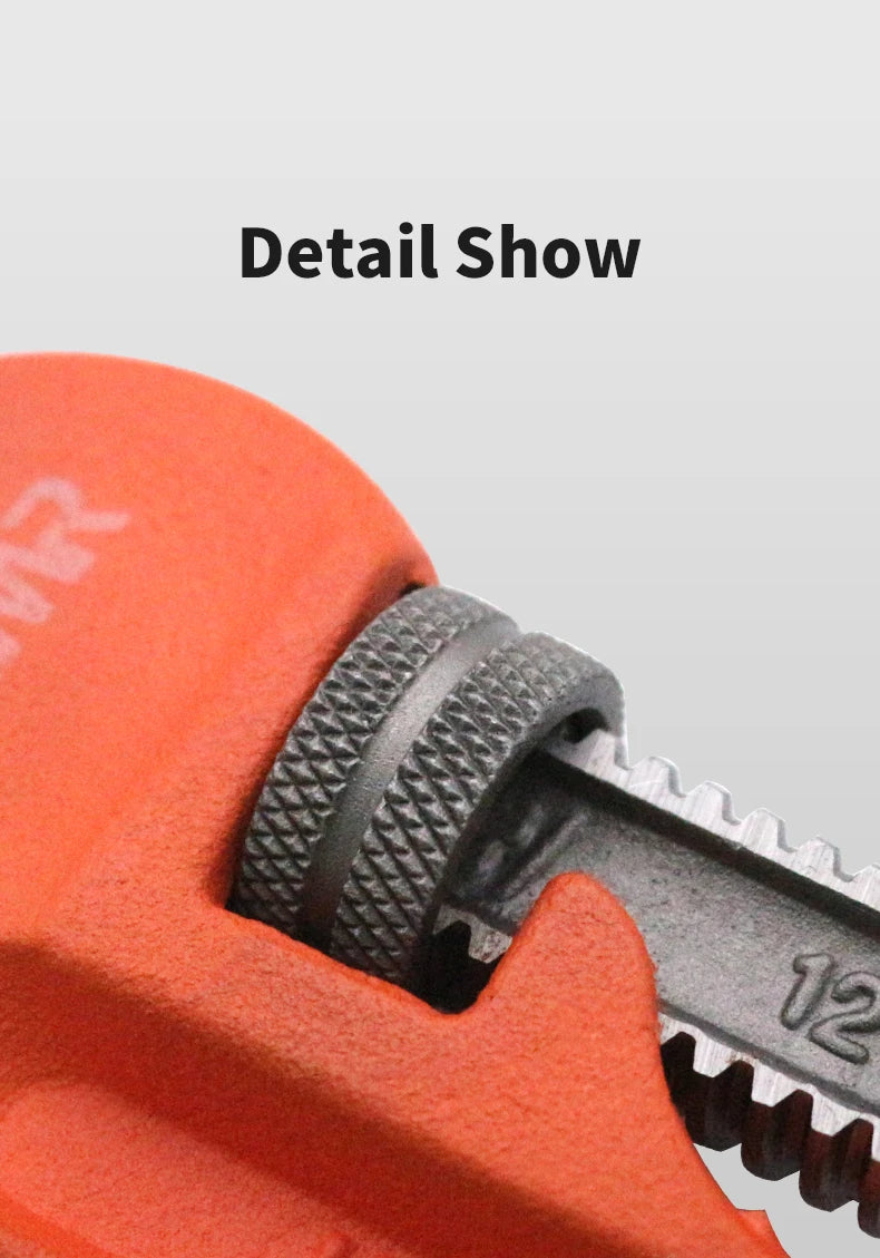 Close-up of a pipe wrench with an orange handle and metallic body on a light gray background.
